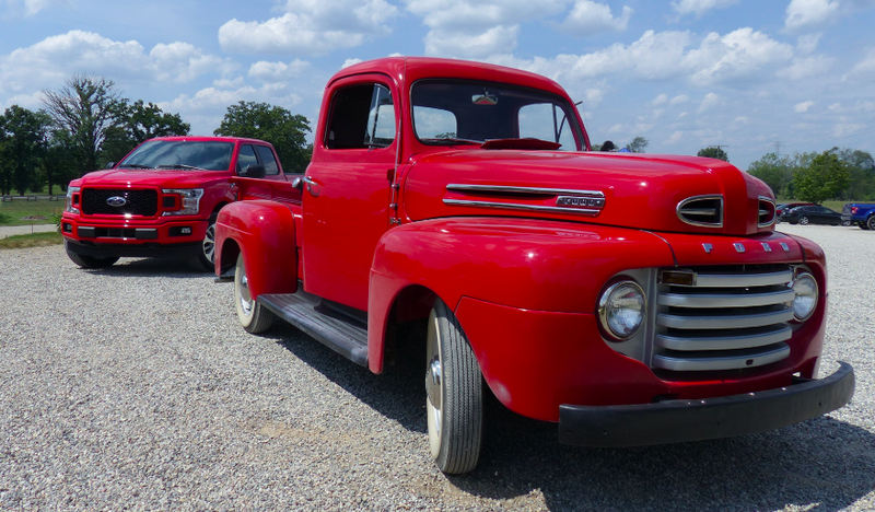 A ~1950 Ford F1 pickup in front of a 2018 F-150.